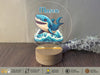 a glass plaque with a picture of a shark on it