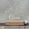 a clear acrylic sign with stars and the name of an individual