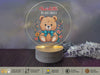 a glass ornament with a teddy bear on it