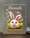 a glass plaque with a bunny in a flower pot