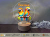 a couple of birds sitting on top of a wooden table