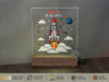a glass block with a picture of a rocket on it