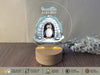 a glass plate with a picture of a penguin inside of a igloose