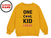 a yellow sweatshirt with the words one cool kid lucas printed on it