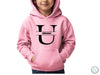 a young boy wearing a pink hoodie with the letter u on it