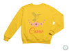 a yellow sweatshirt with a bird and flowers on it