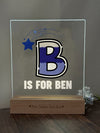 a glass block with the letter b is for ben